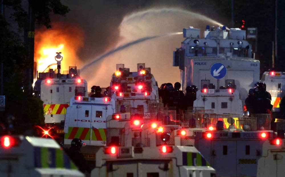 Police deploy water cannon as Northern Ireland unrest enters second night after Belfast stabbing